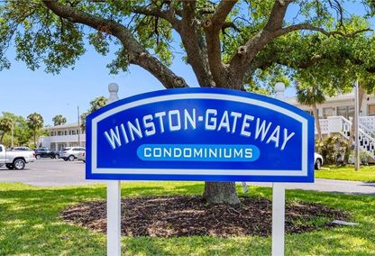 Winston Gateway Condominiums neighborhood sign under a tree