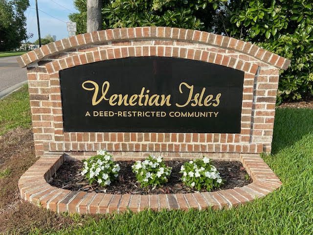Venetian Isles Neighborhood sign with flowers